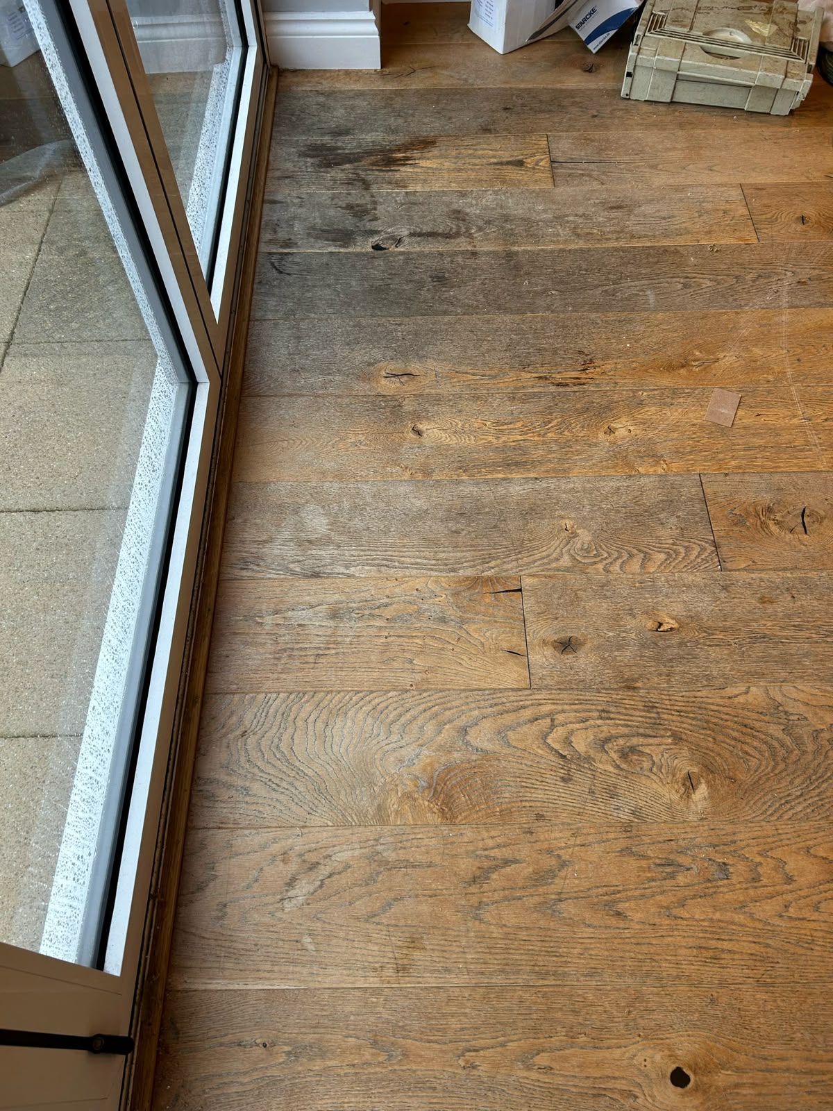 Oak floor by patio doors before sanding and refinishing